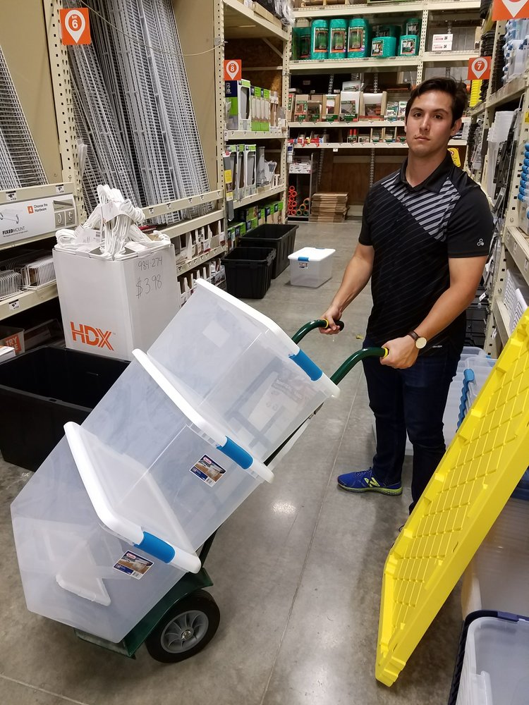 Photo of Jordan in Home Depot with bins on a dolly.